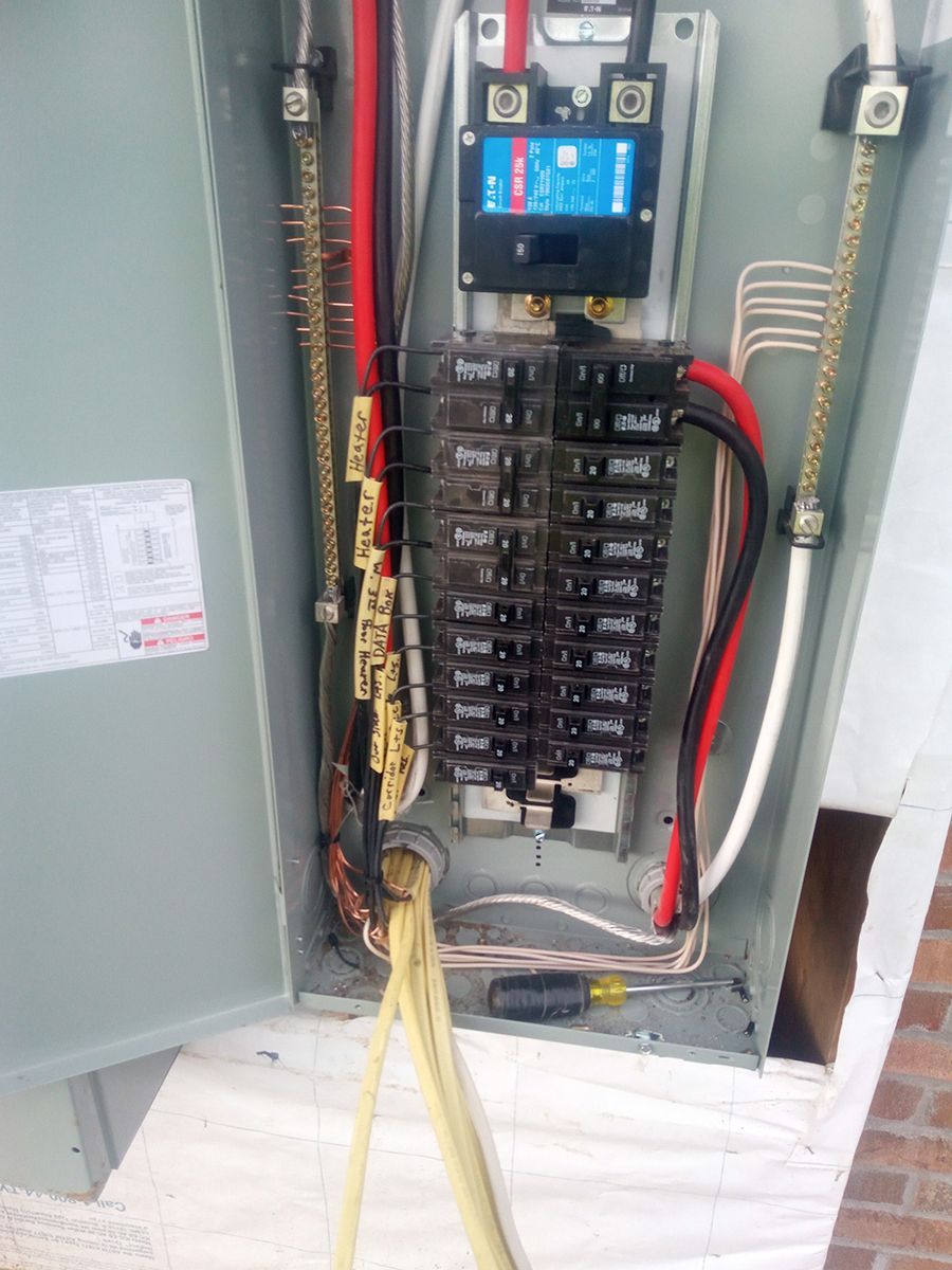 A close up of an electrical box with wires coming out of it.