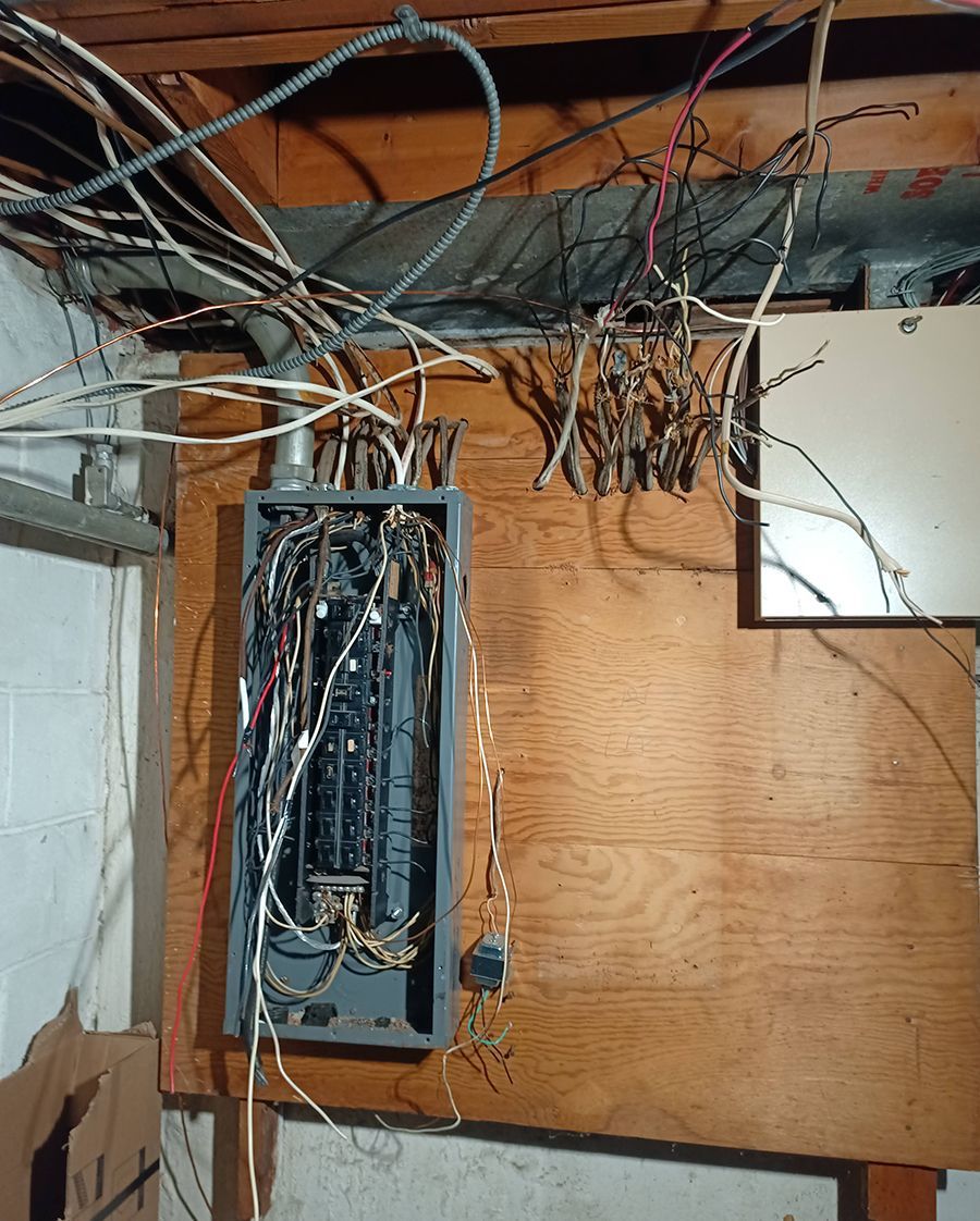 A bunch of wires are hanging from the ceiling.
