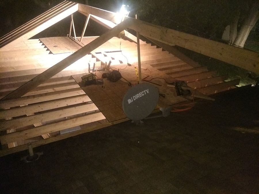 A satellite dish is sitting on top of a wooden floor.