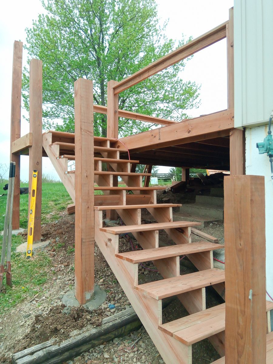 A wooden deck with stairs leading up to it.