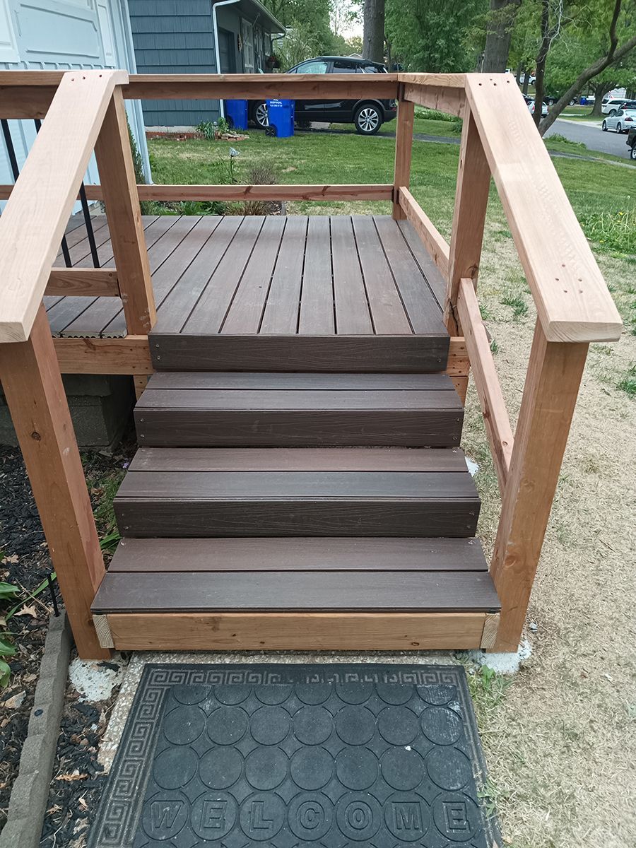 A wooden deck with stairs leading up to it.