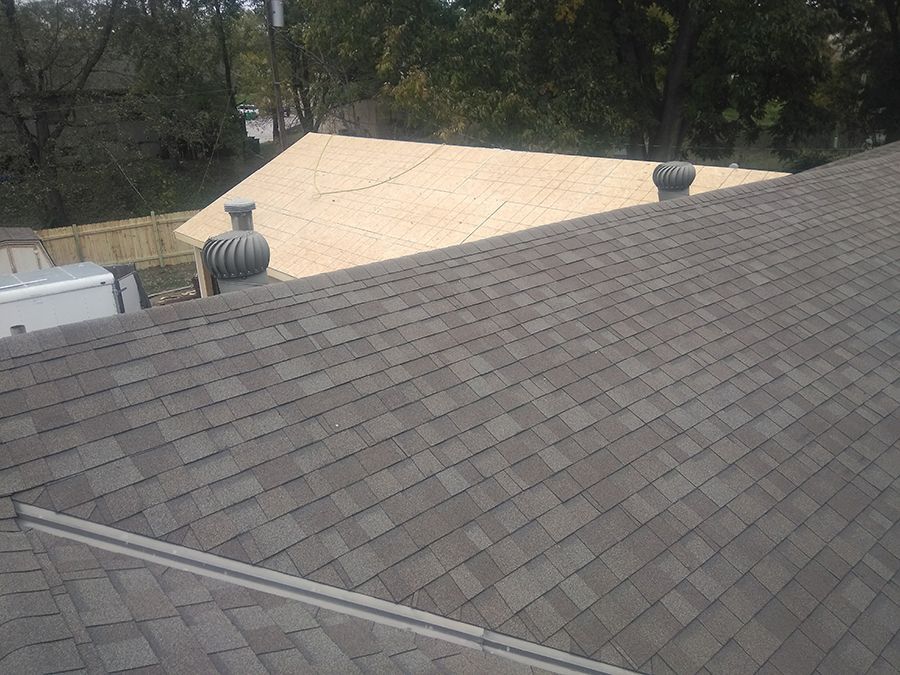 A roof with shingles and a chimney on it is being built.