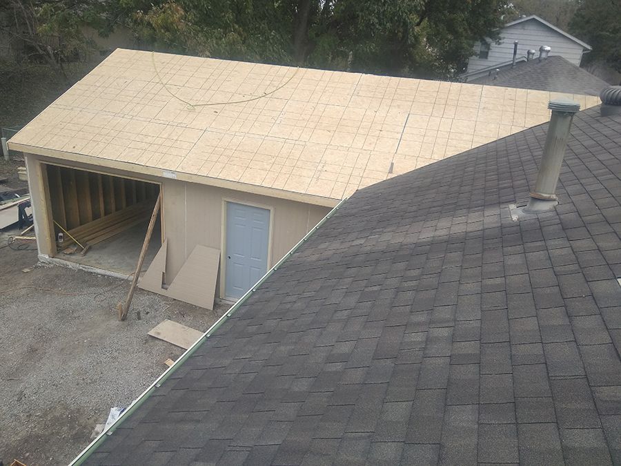 A garage is being built and the roof is being installed.