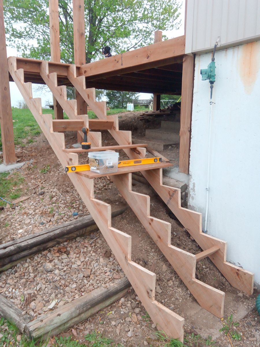 A wooden staircase is being built next to a building.