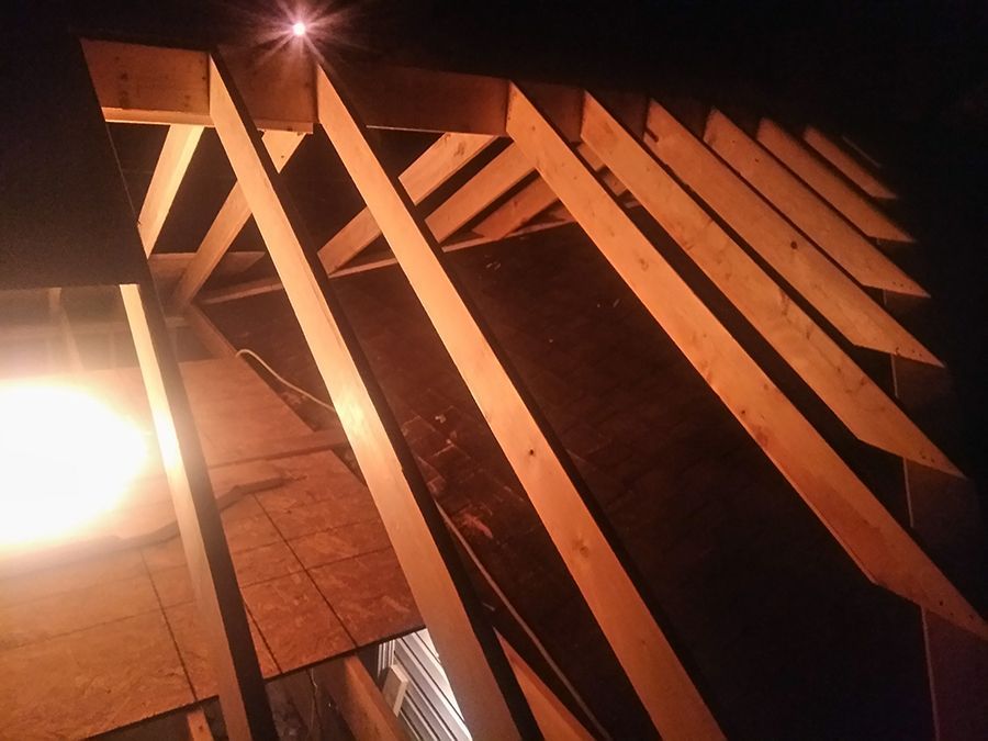 A wooden structure with a light shining through it.