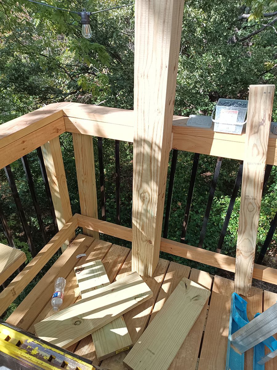 A wooden deck is being built with wooden boards and a level.