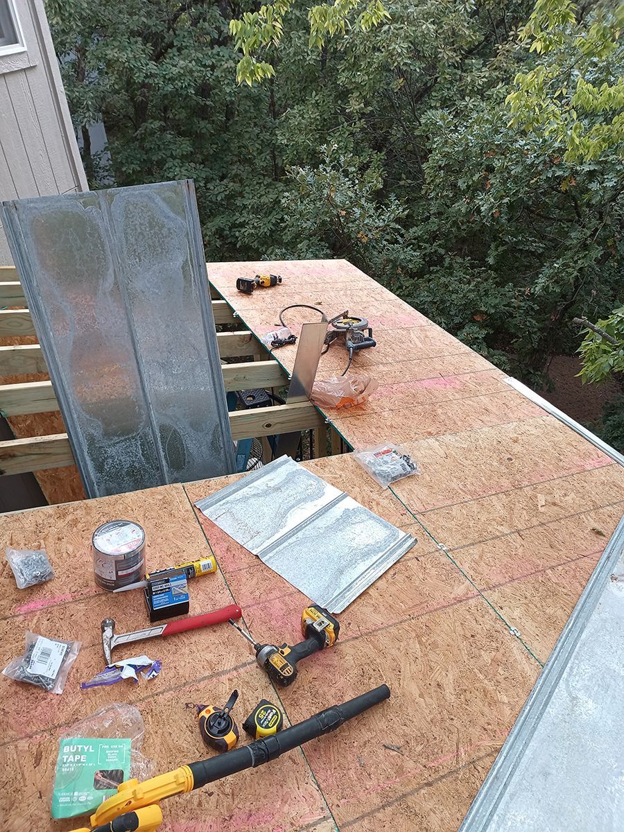 A roof is being built with a lot of tools on it.