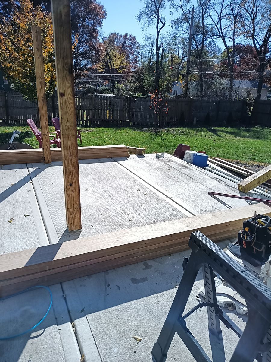 A wooden structure is being built in a backyard.