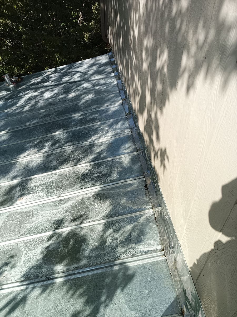 A shadow of a tree is cast on the side of a building.