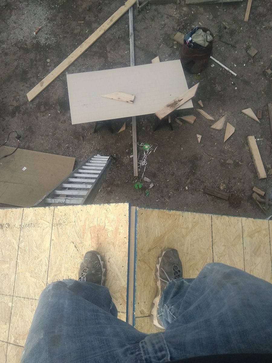 A person standing on top of a wooden floor.