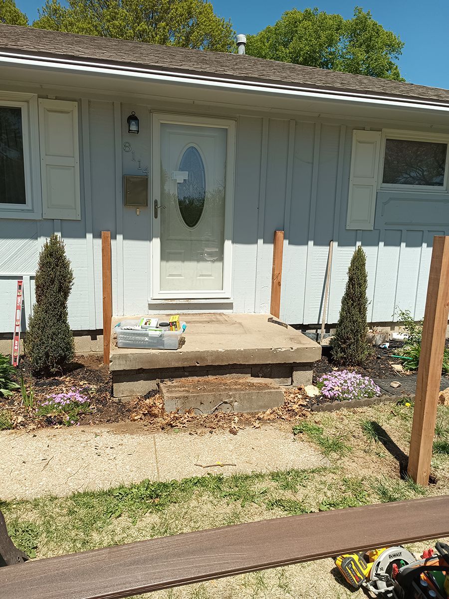 A house with a wooden fence in front of it.
