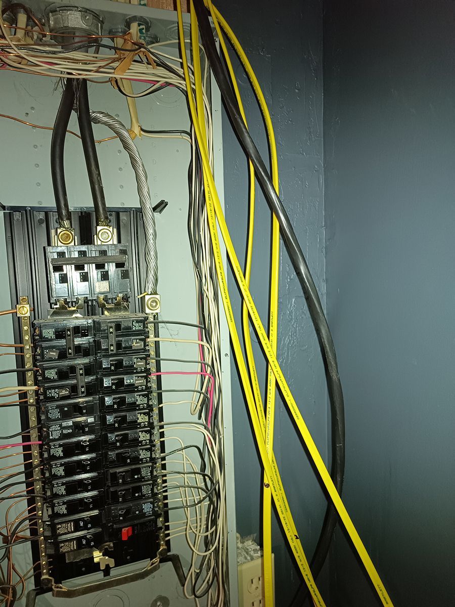 A bunch of wires are connected to an electrical box.