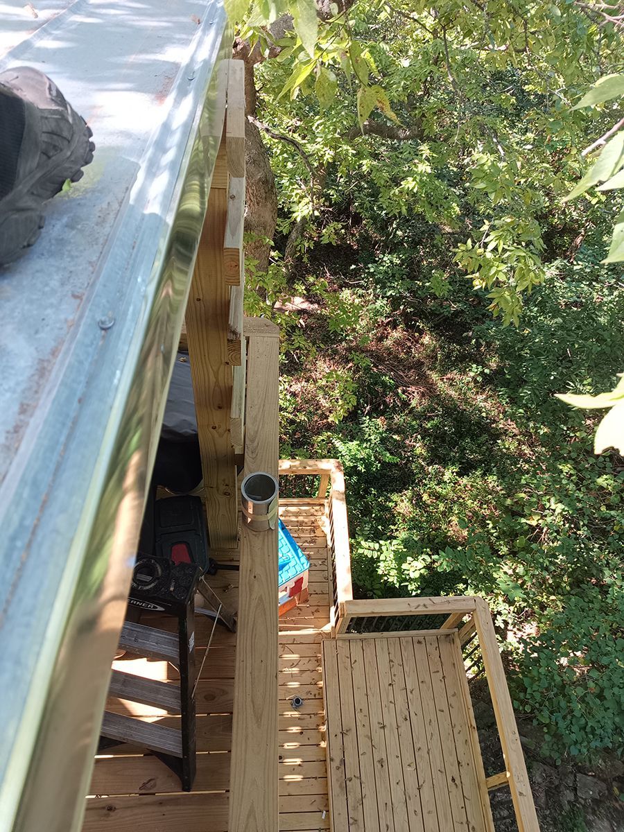 An aerial view of a wooden deck with trees in the background.