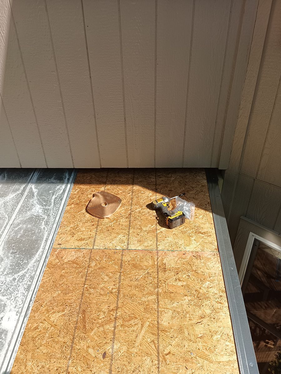 A piece of plywood is sitting on top of a wooden floor.