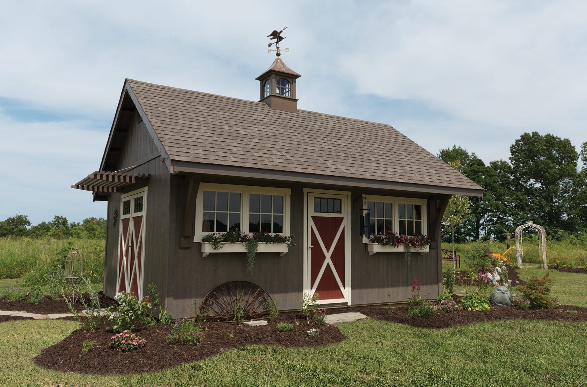 A small house with a weather vane on top of it