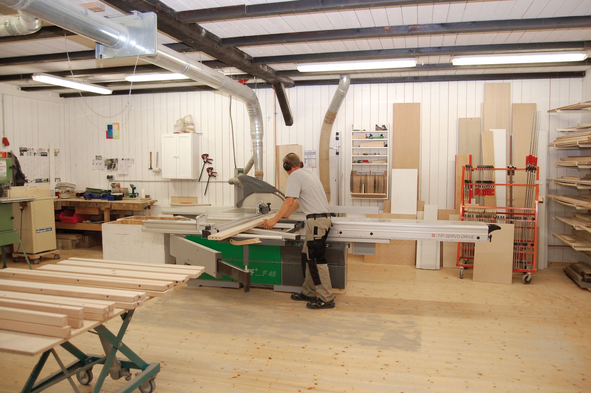 Happy baby in a crib, smiling, with a mobile overhead
