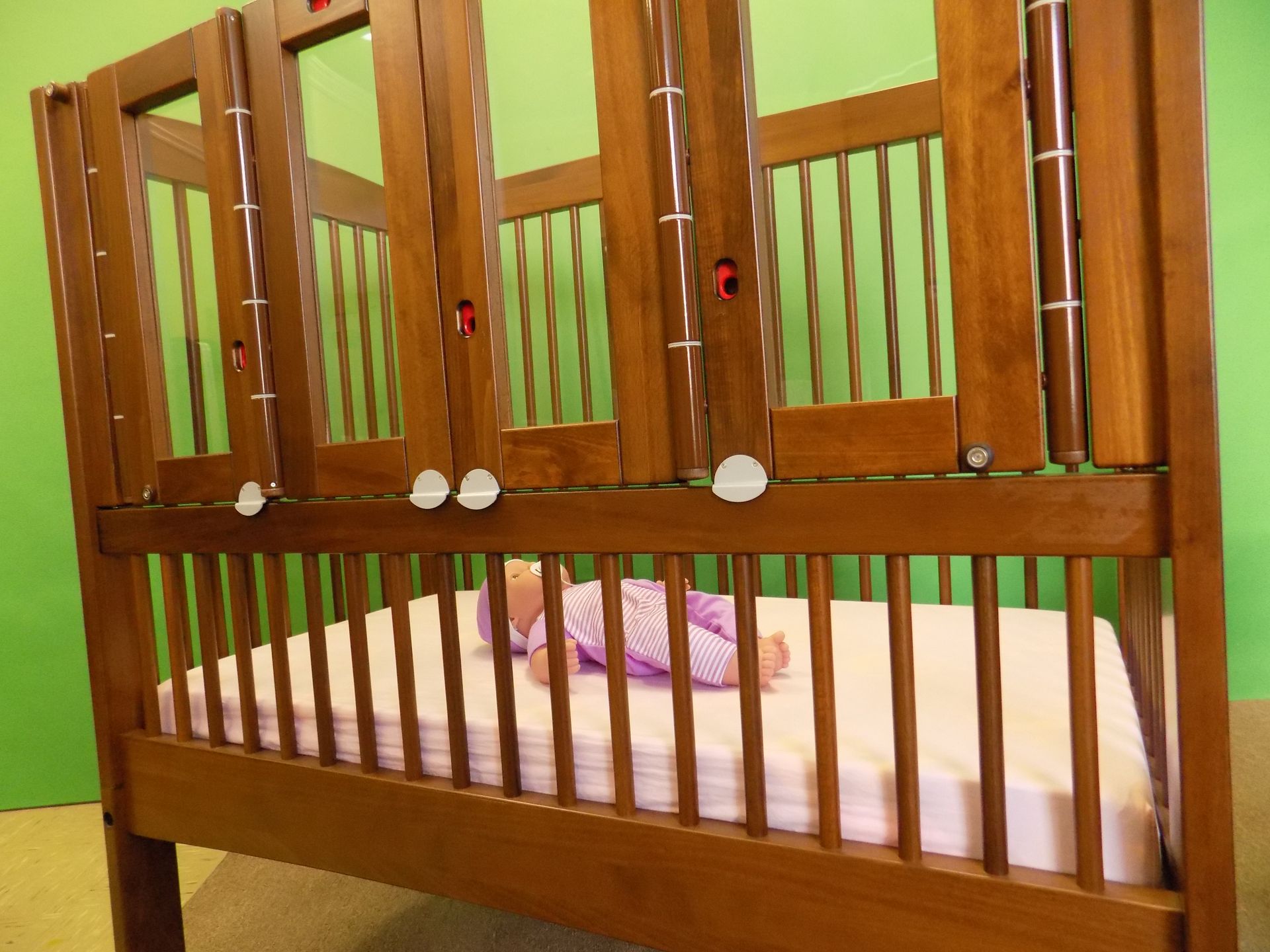Baby lying in a wooden crib