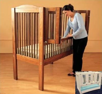 A woman is standing next to a Gertie Crib