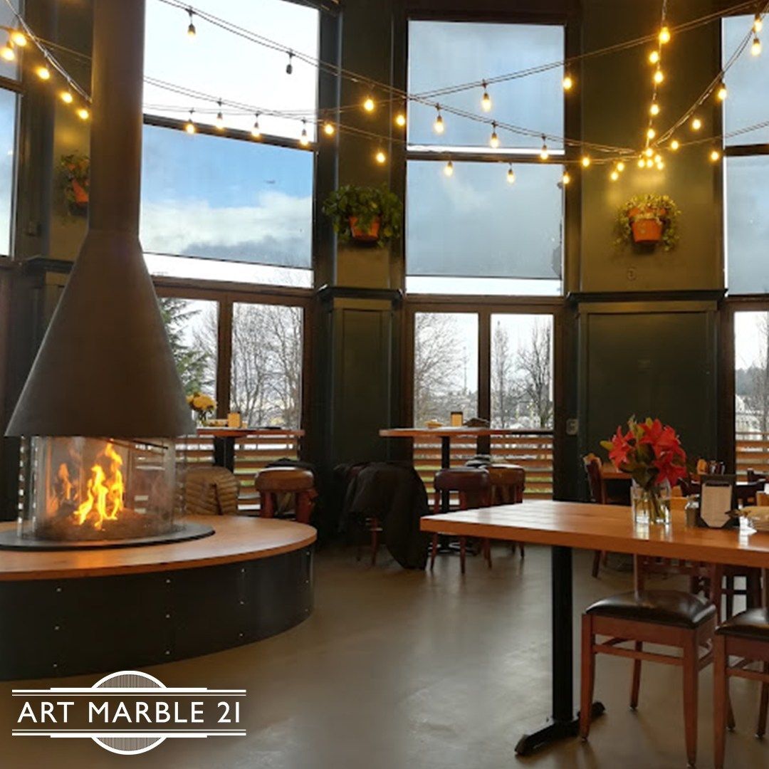Tables and chairs and a fireplace at Art Marble 21