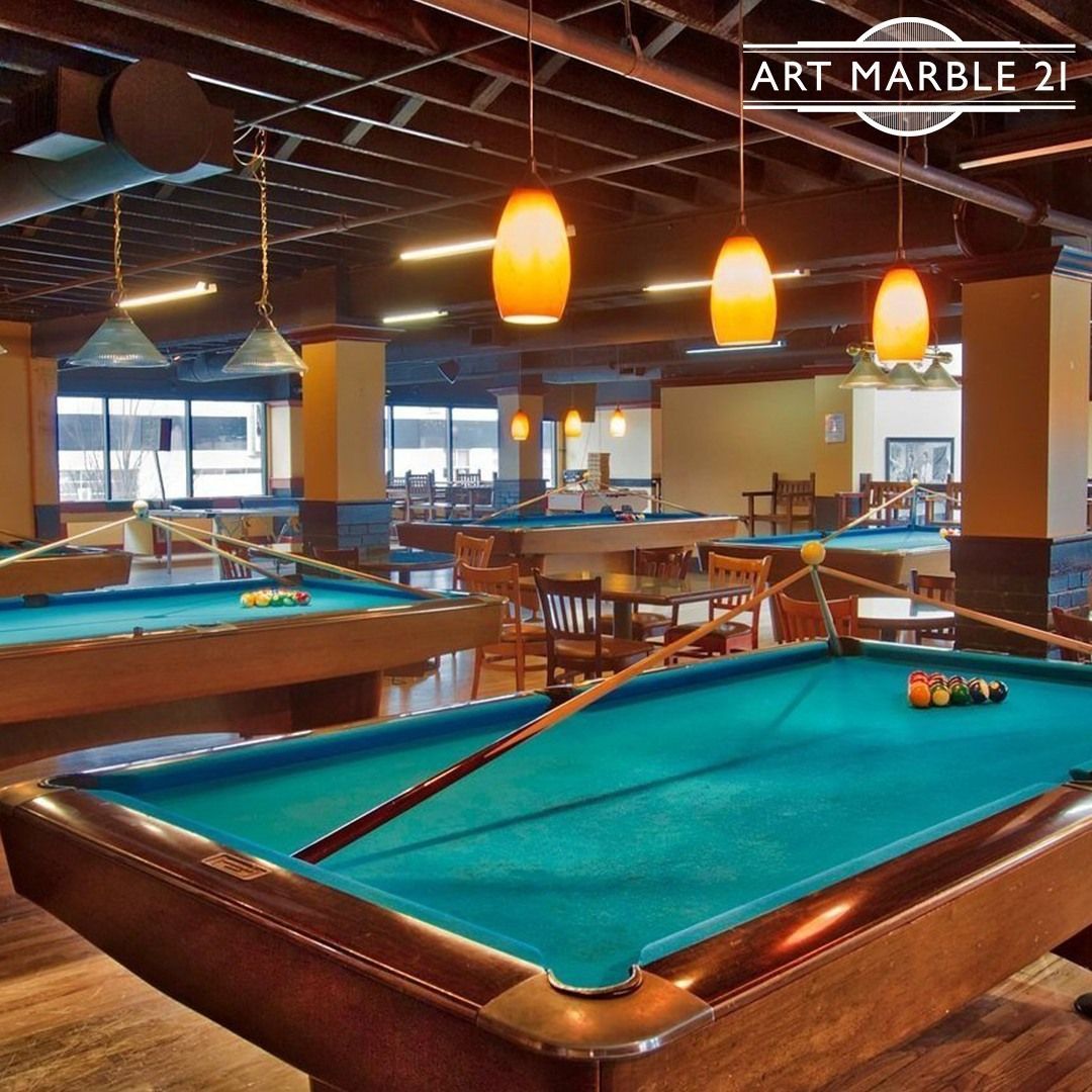 A pool table in an Art Marble 21 pool hall