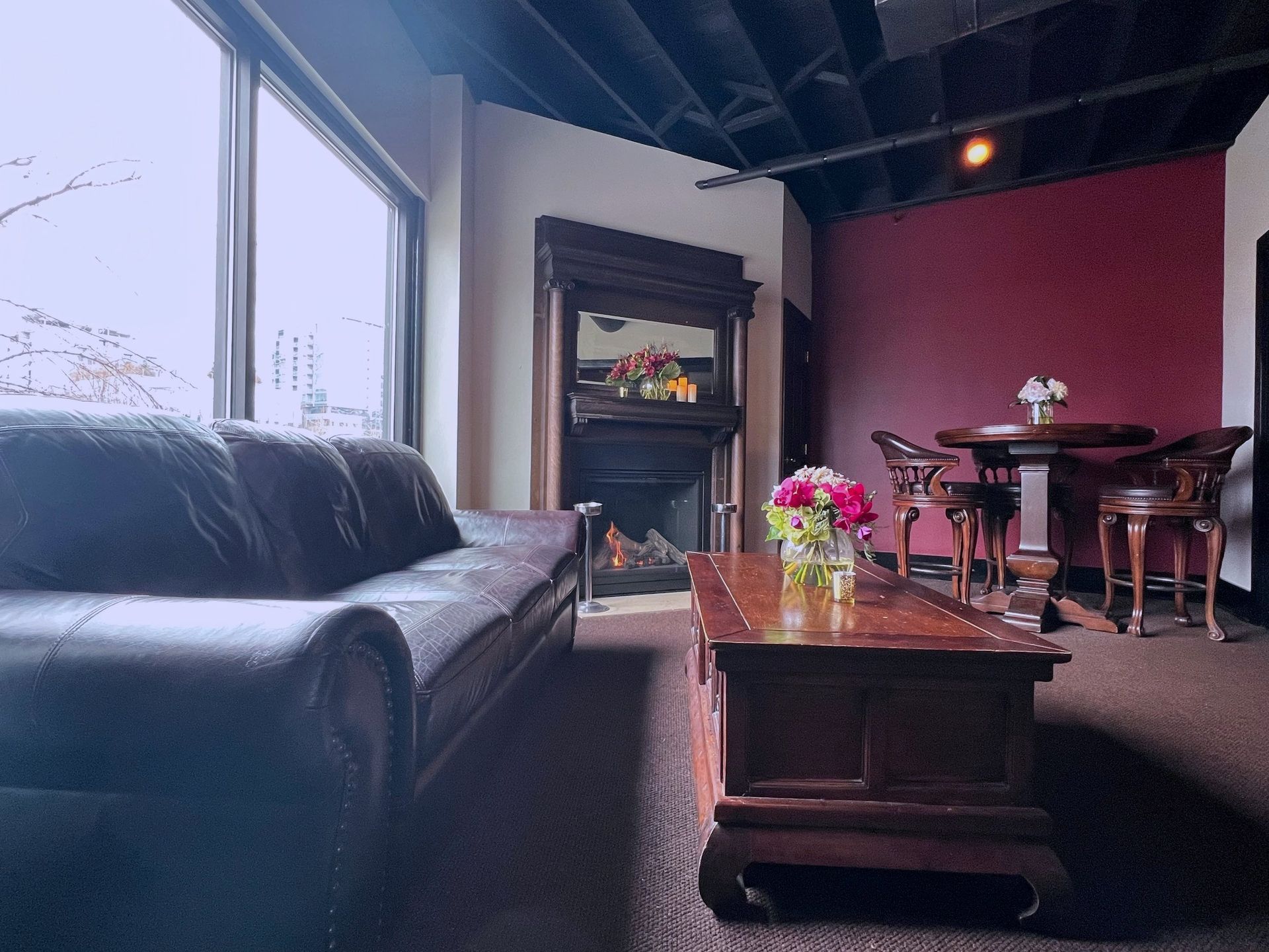 A living room with a couch a table and a fireplace