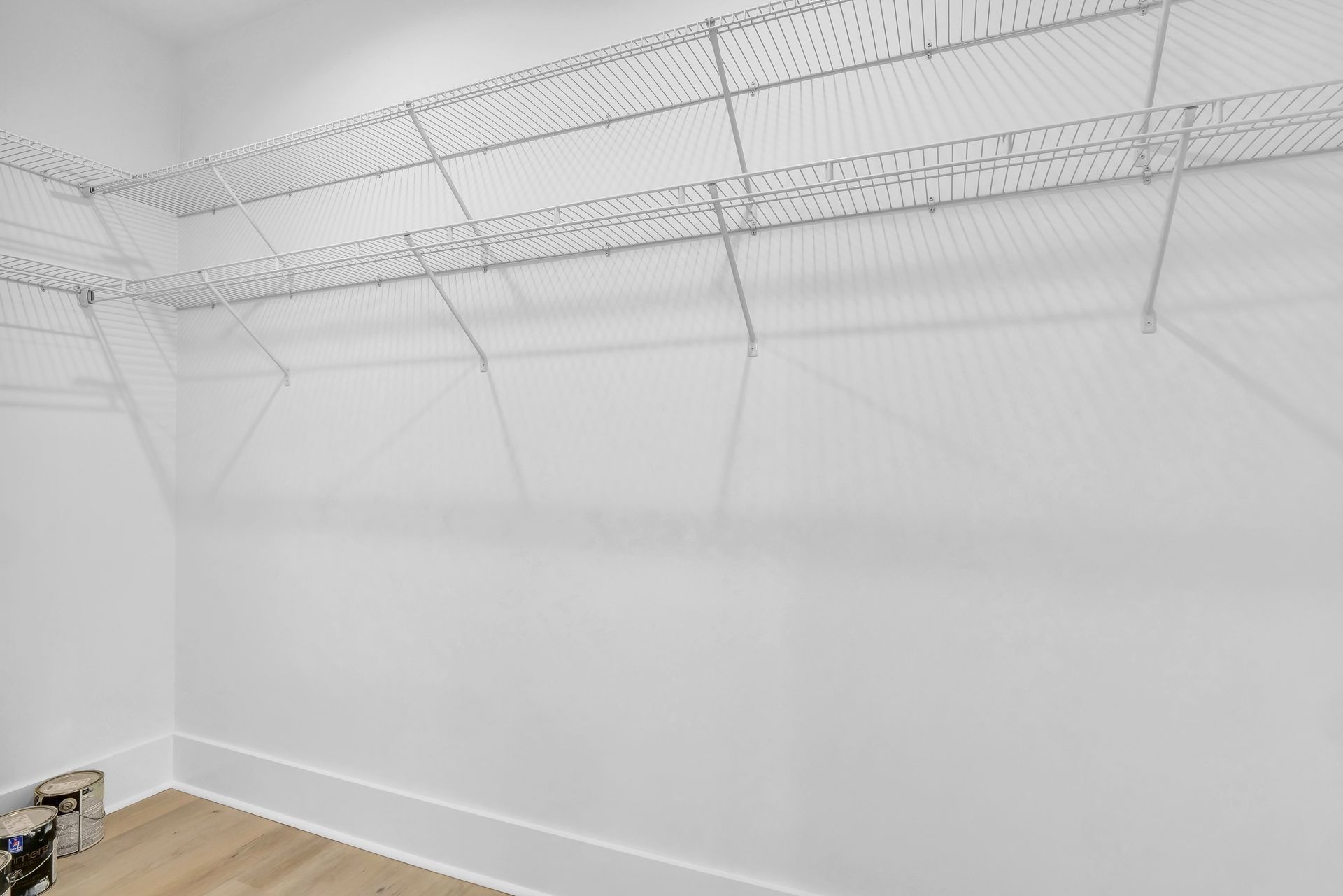 Empty white closet with wire shelving.