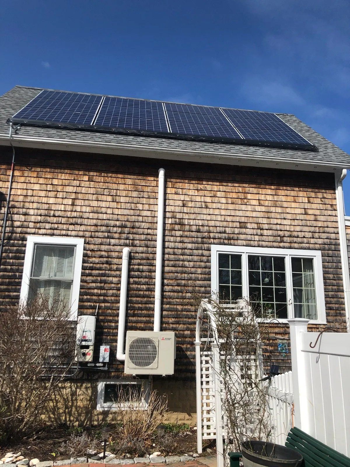 A house with a lot of solar panels on the roof.