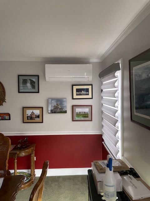 A room with red walls and a white air conditioner