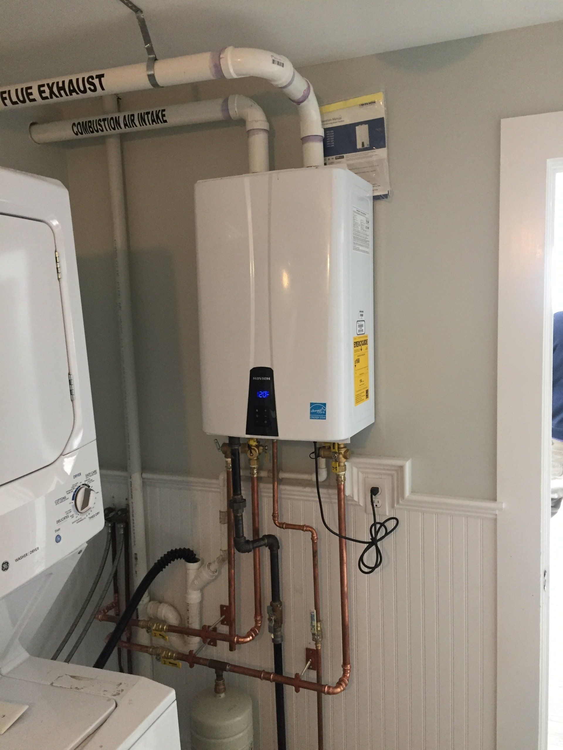 A laundry room with a washer and dryer and a water heater.