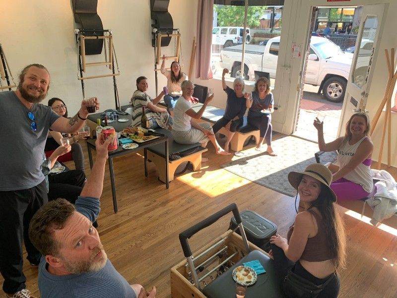 A group of people are sitting around a table in a room.