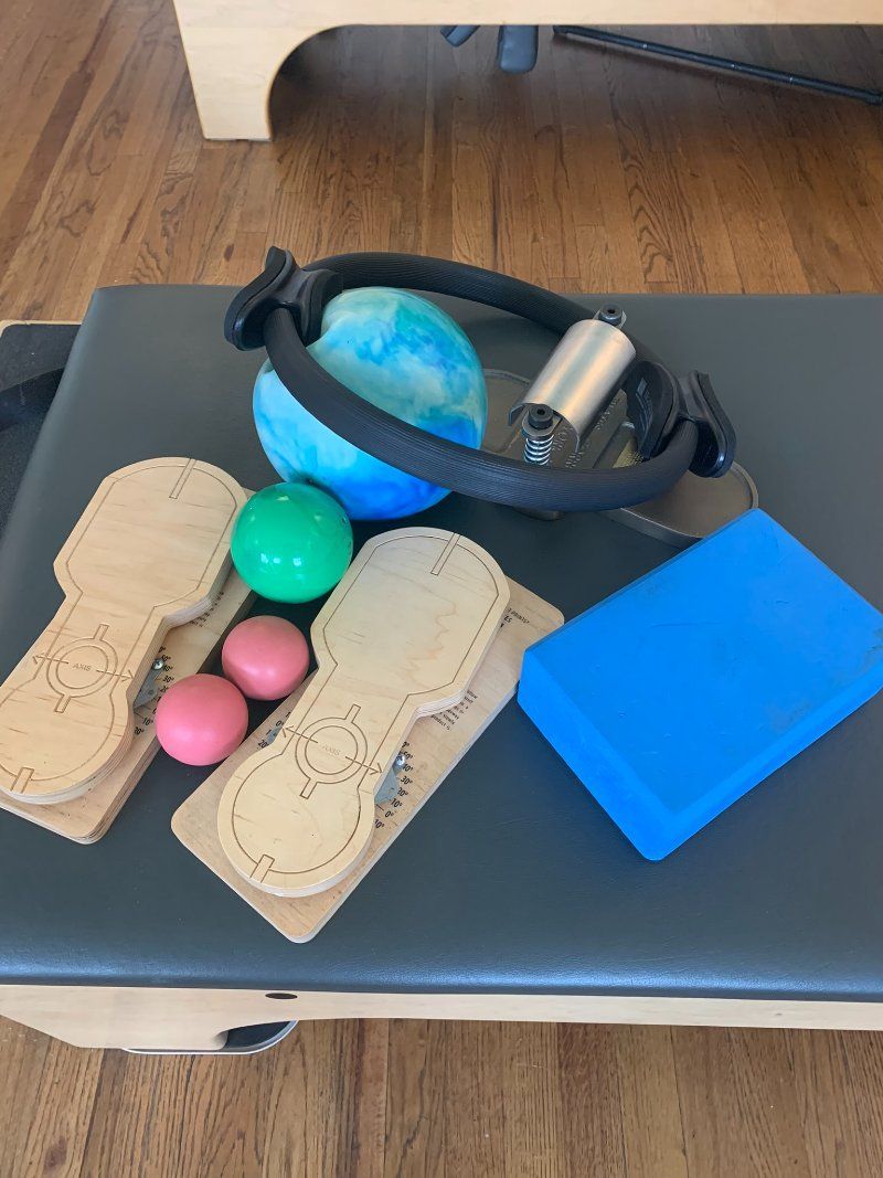 A pilates mat with balls and blocks on it