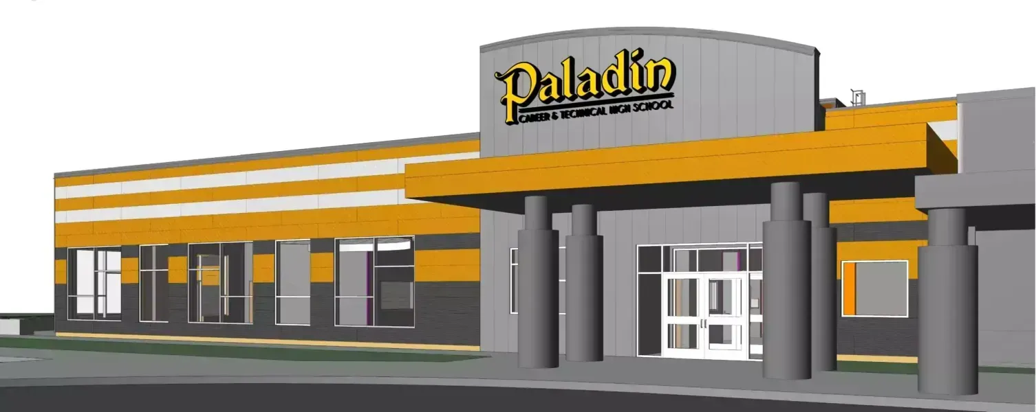 Exterior view of the Paladin theater. Building has yellow and grey accents with a yellow overhang and pillars at the entrance.