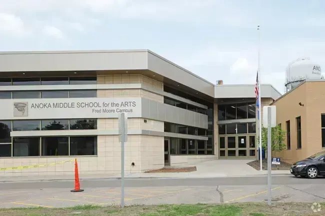 Anoka Middle School in Anoka, Minnesota, exterior view with flagpole and water tower.
