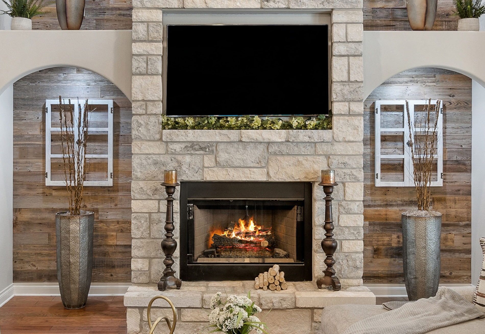 A living room with a fireplace and a flat screen tv.