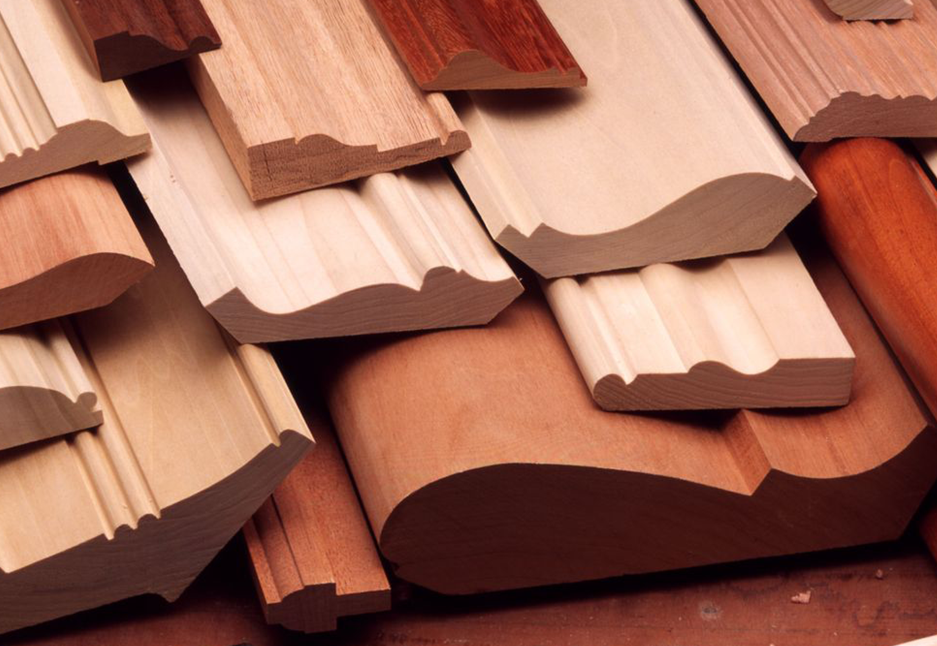 A bunch of different types of wood mouldings are stacked on top of each other