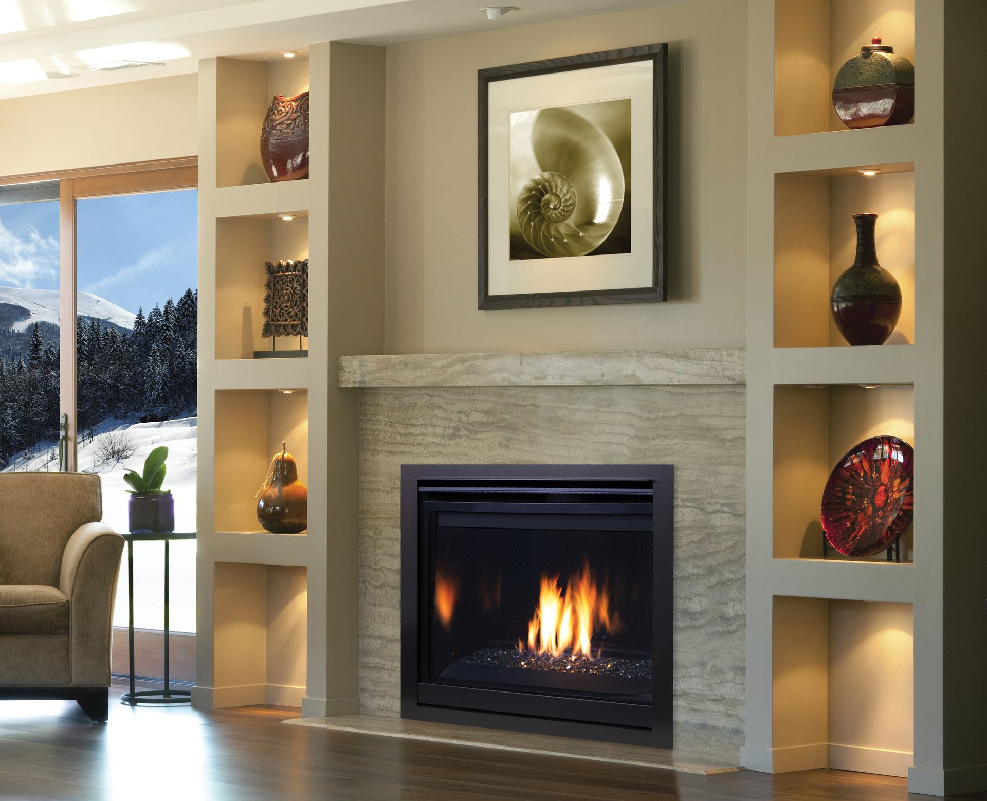 Modern living room with lit fireplace, built-in shelves, and large window view of snowy landscape