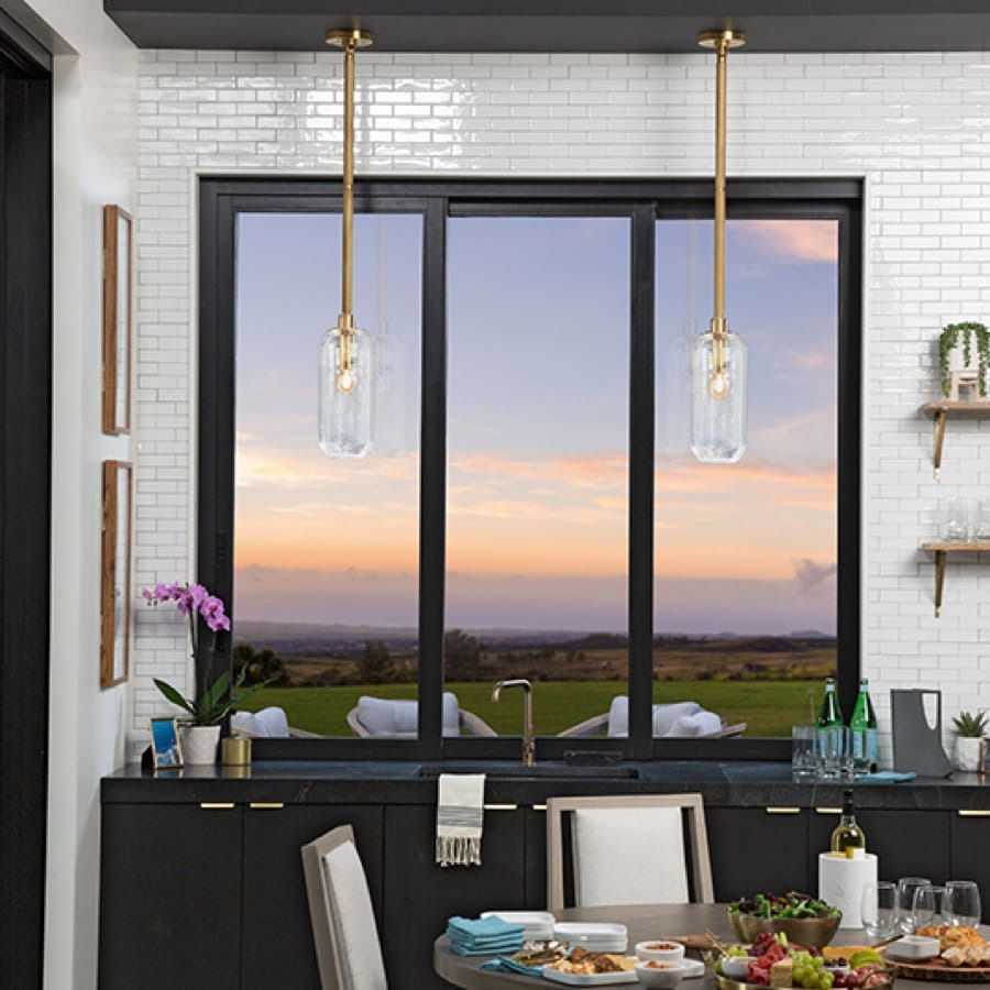A kitchen with a table and chairs and a large window