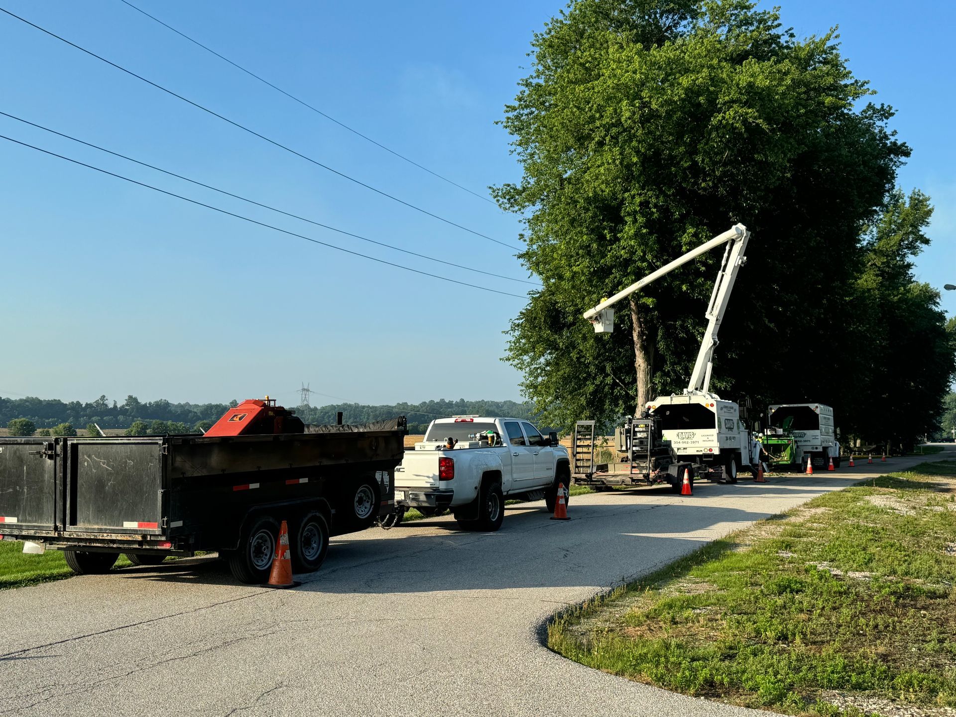Several trucks are parked on the side of the road
