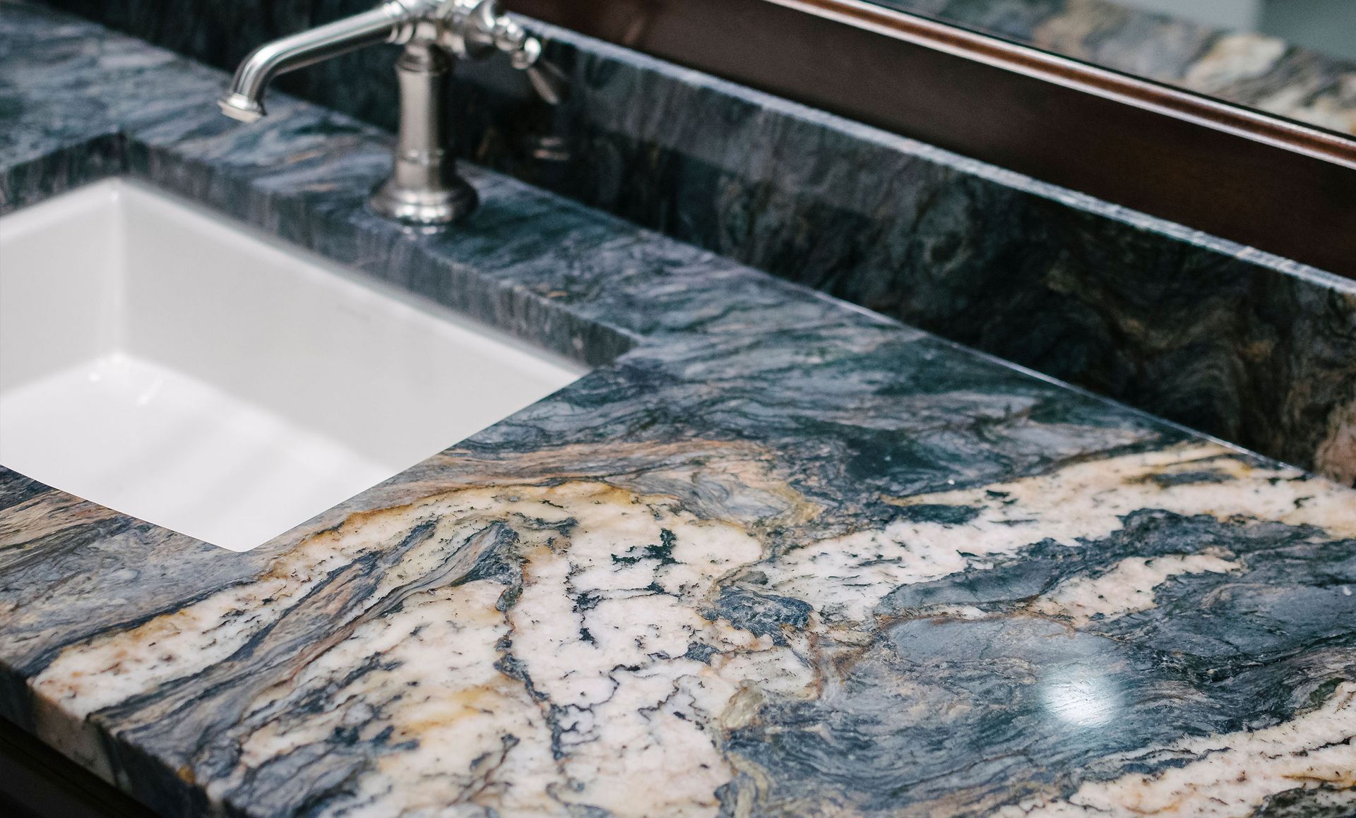 Granite bathroom countertop with white sink and chrome faucet