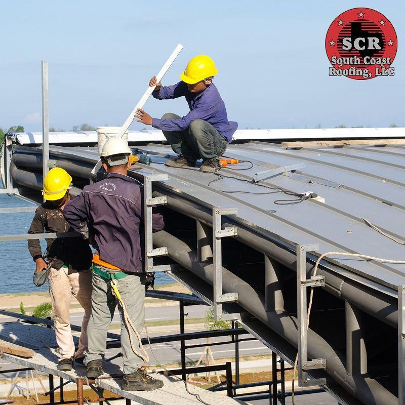 A group of construction workers are working on a roof sponsored by scr south carolina roofing