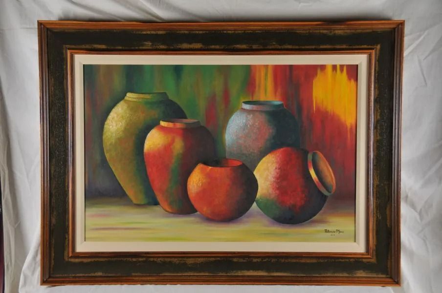 Framed still-life painting of colorful fruit and vases with warm abstract background