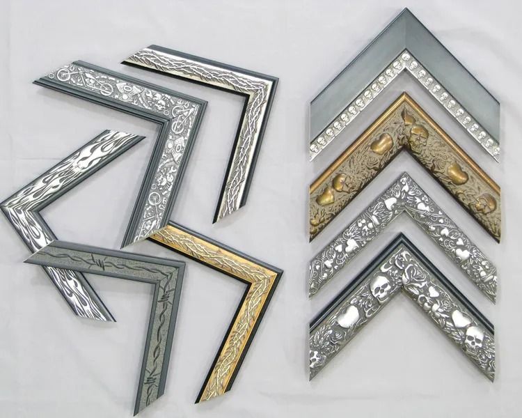 Decorative chevron picture frame corners in silver, gold, and gray arranged on a white background