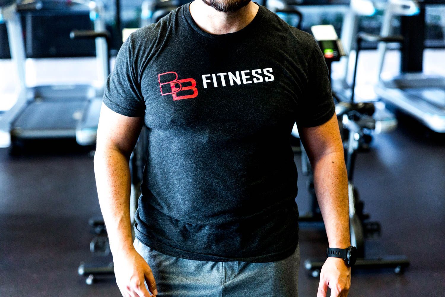 Person in a gym wearing a dark gray 