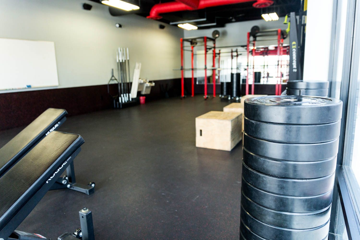 Gym interior with weights, benches, and workout equipment.