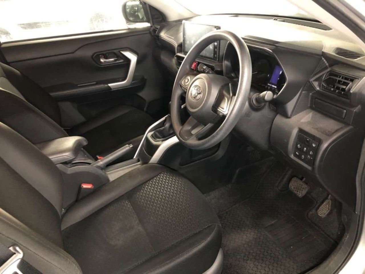 Interior of a gray Toyota car, with black seats, steering wheel, and dashboard.