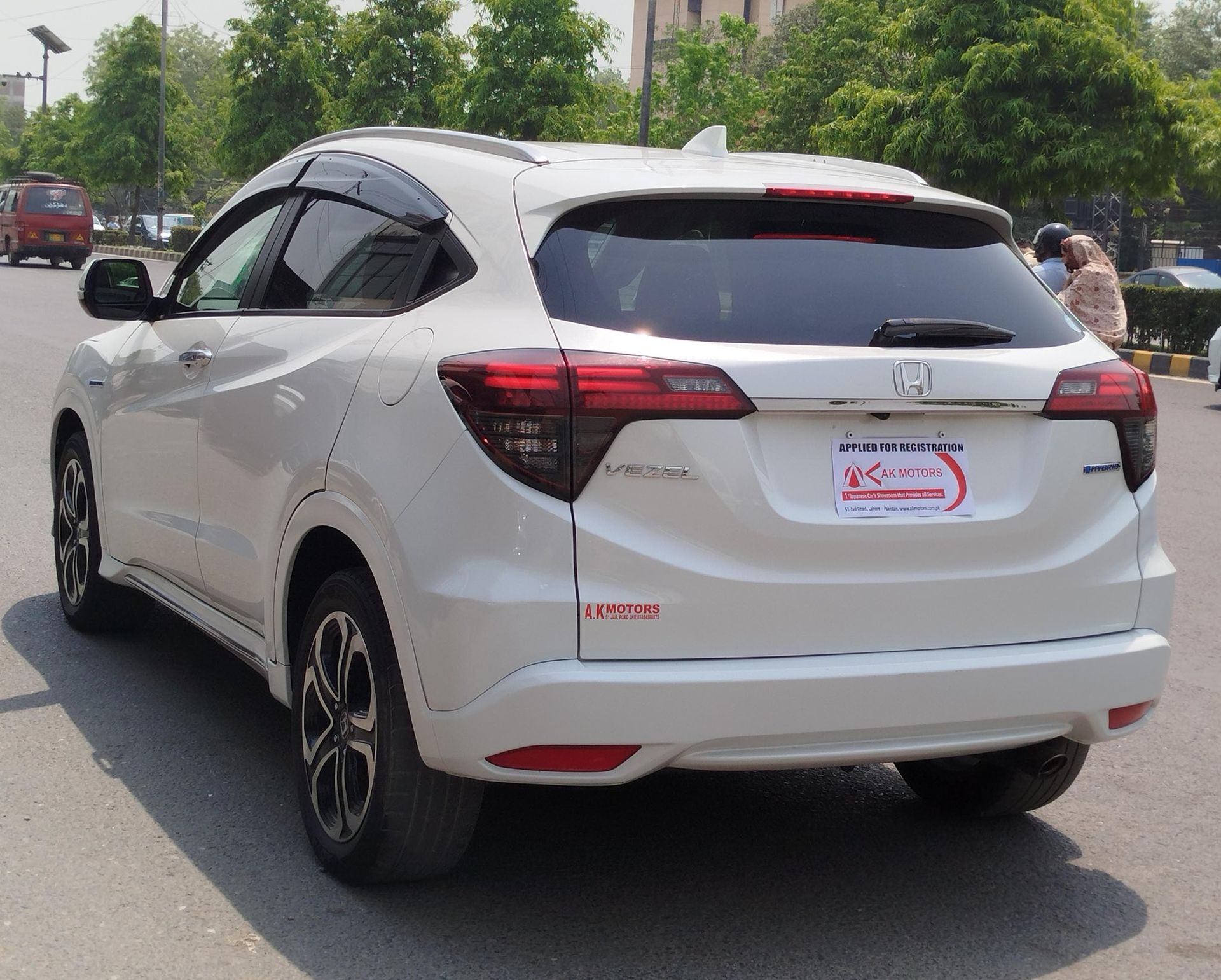 White Honda Vezel SUV parked on a road.
