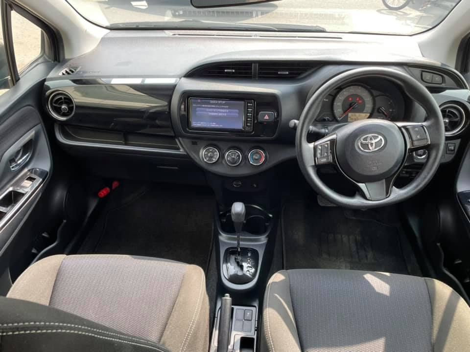 Interior of a Toyota car showing the dashboard, steering wheel, and seats.