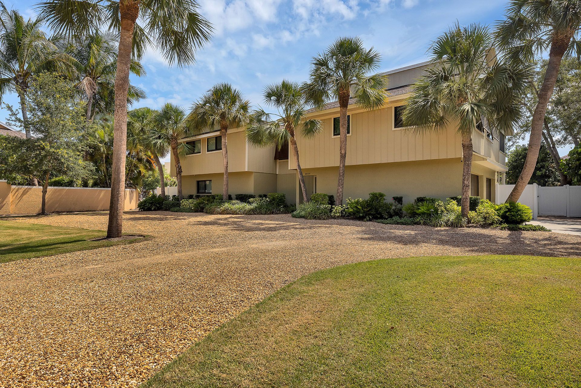 A large house with palm trees in front of it