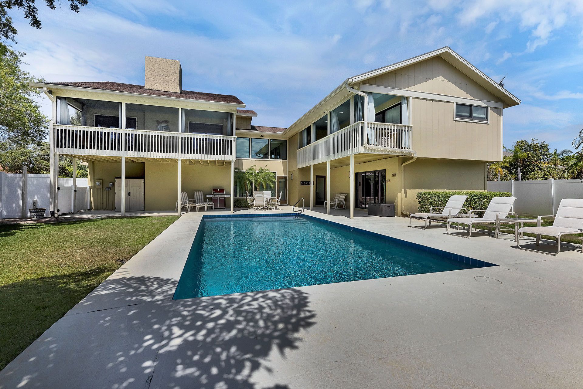 A large house with a large swimming pool in front of it