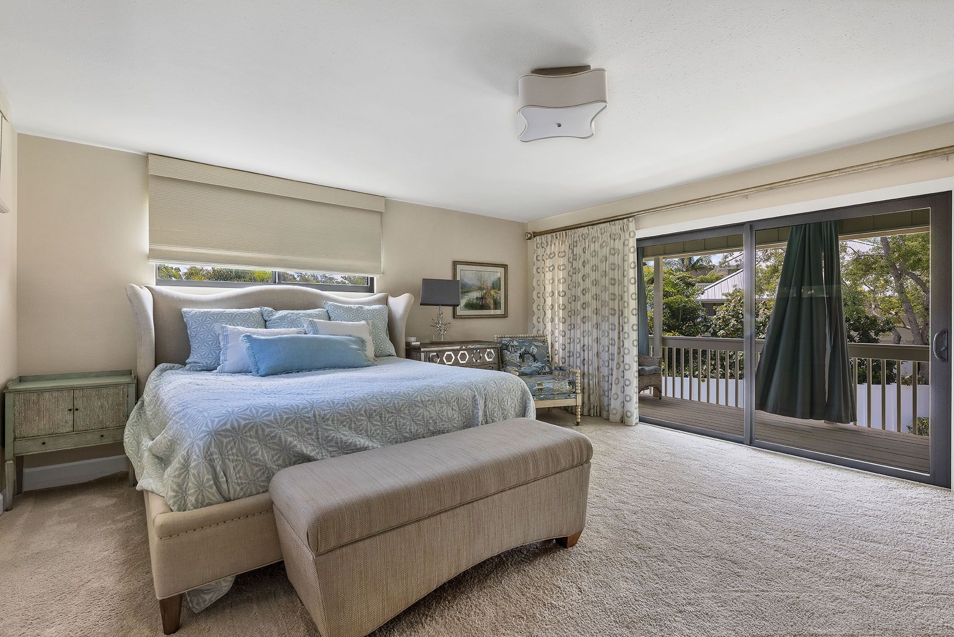 A bedroom with a large bed and sliding glass doors